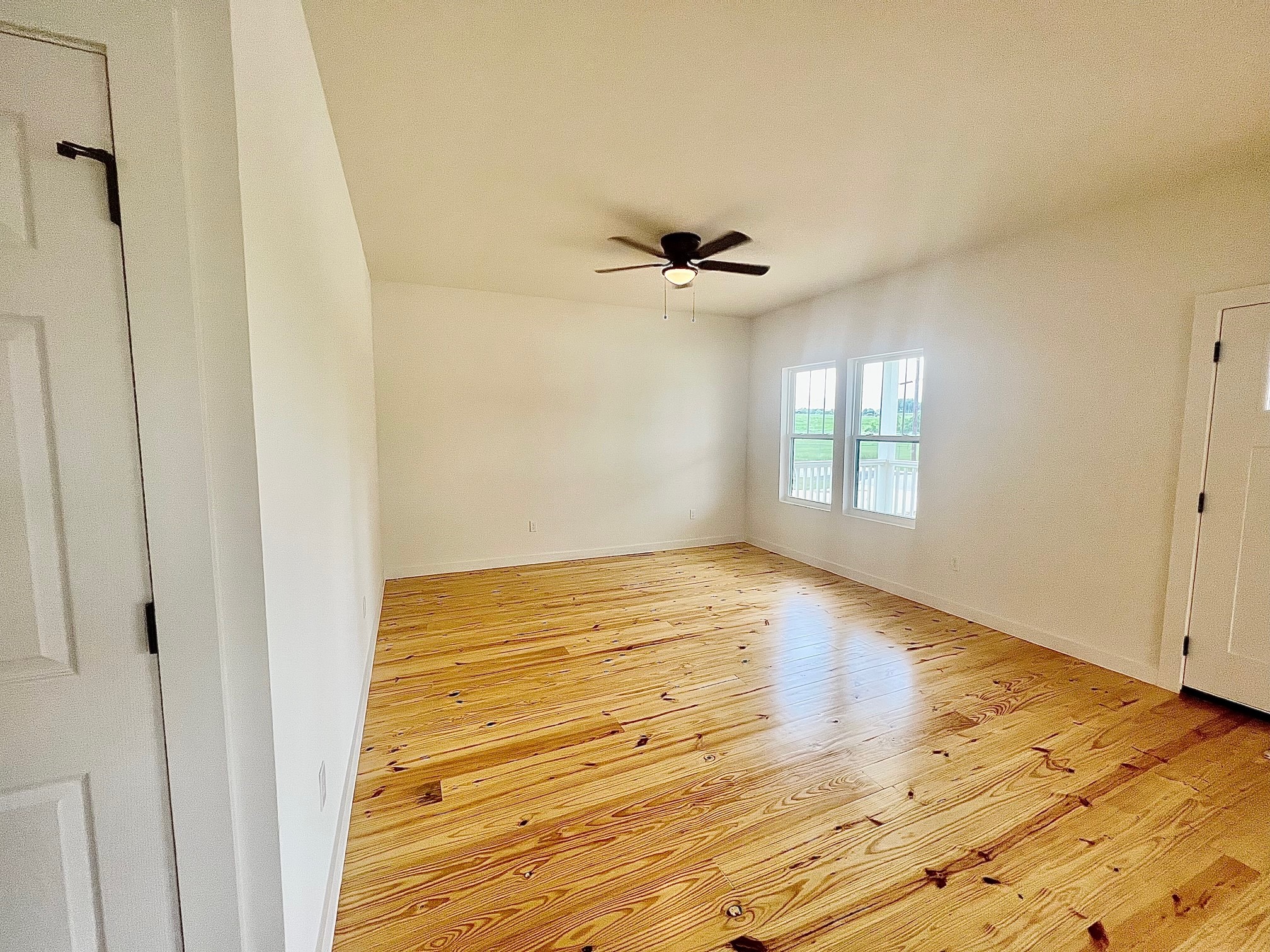228 North Dixie Street Brenham, TX 77833 - Photo 2 of 10 a view of empty room with wooden floor and fan