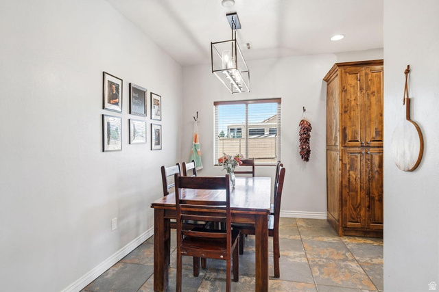 7776 Wagon Road East St. George, UT 84770 - Photo 16 of 76 Dining space with stone tile flooring and a chandelier
