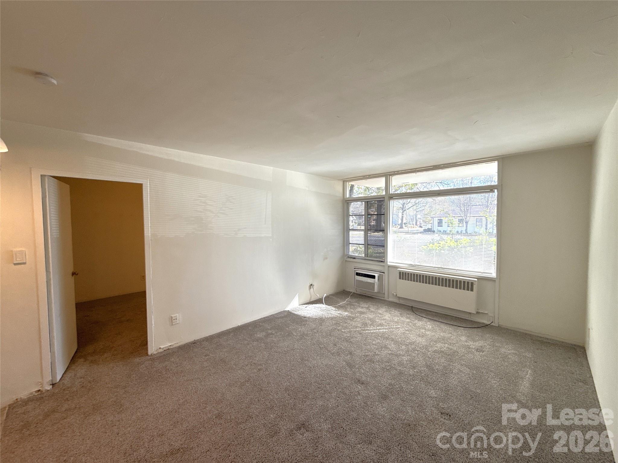 2126 East 7th Street, Unit 103 Charlotte, NC 28204 - Photo 2 of 8 an empty room with windows