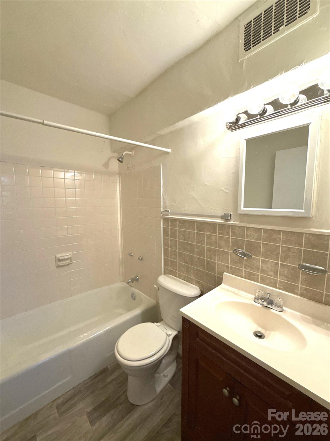 2126 East 7th Street, Unit 103 Charlotte, NC 28204 - Photo 8 of 8 a bathroom with a sink a toilet and shower