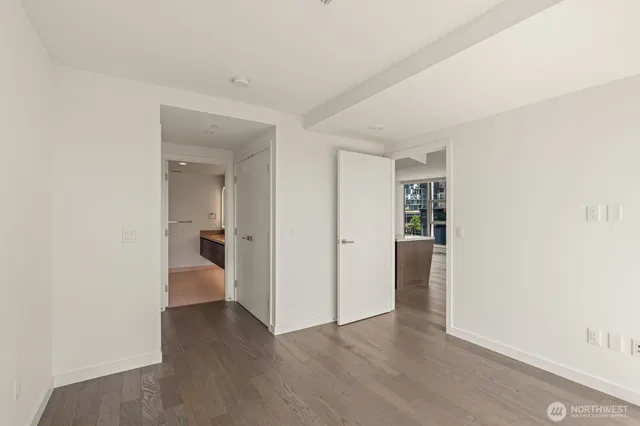 a view of a room with wooden floor and bathroom