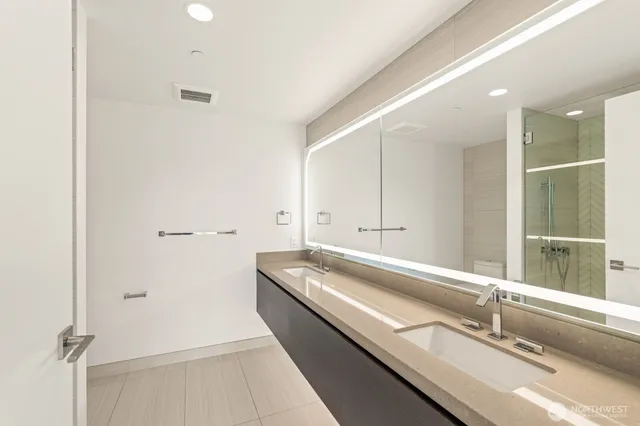 a view of a bathroom with a sink and mirror