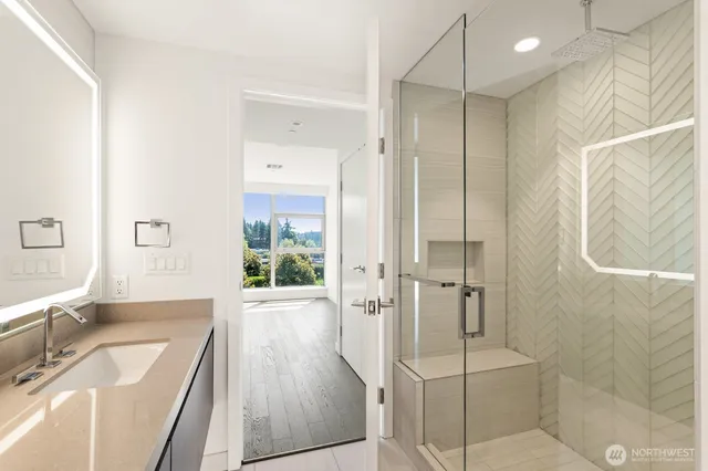 a bathroom with a tub sink shower and mirror
