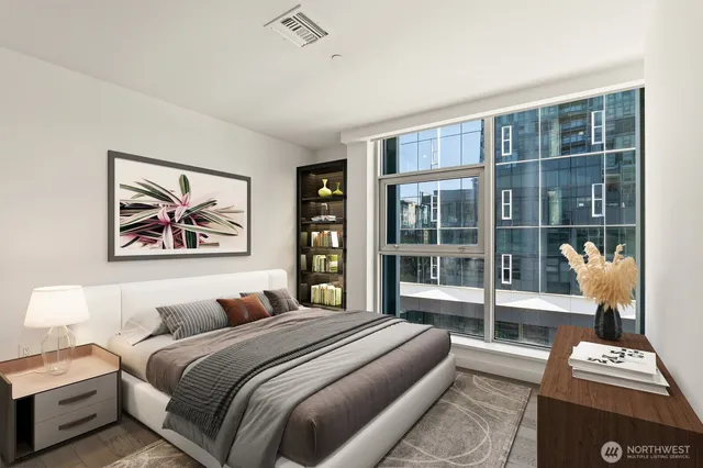 a bedroom with a bed and a large window