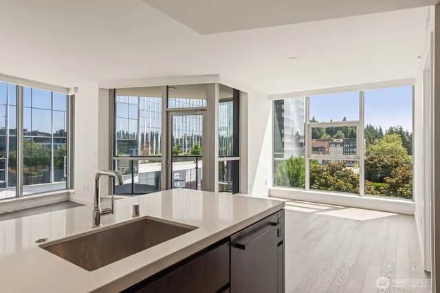 a view of a large kitchen with kitchen island a large window