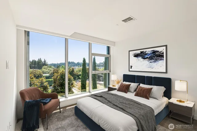 a bedroom with a large bed and a large window