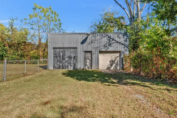 a view of a house with a tree in front of it