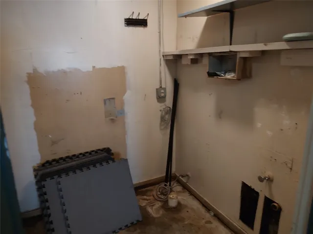 a view of storage and utility room with racks on the wall