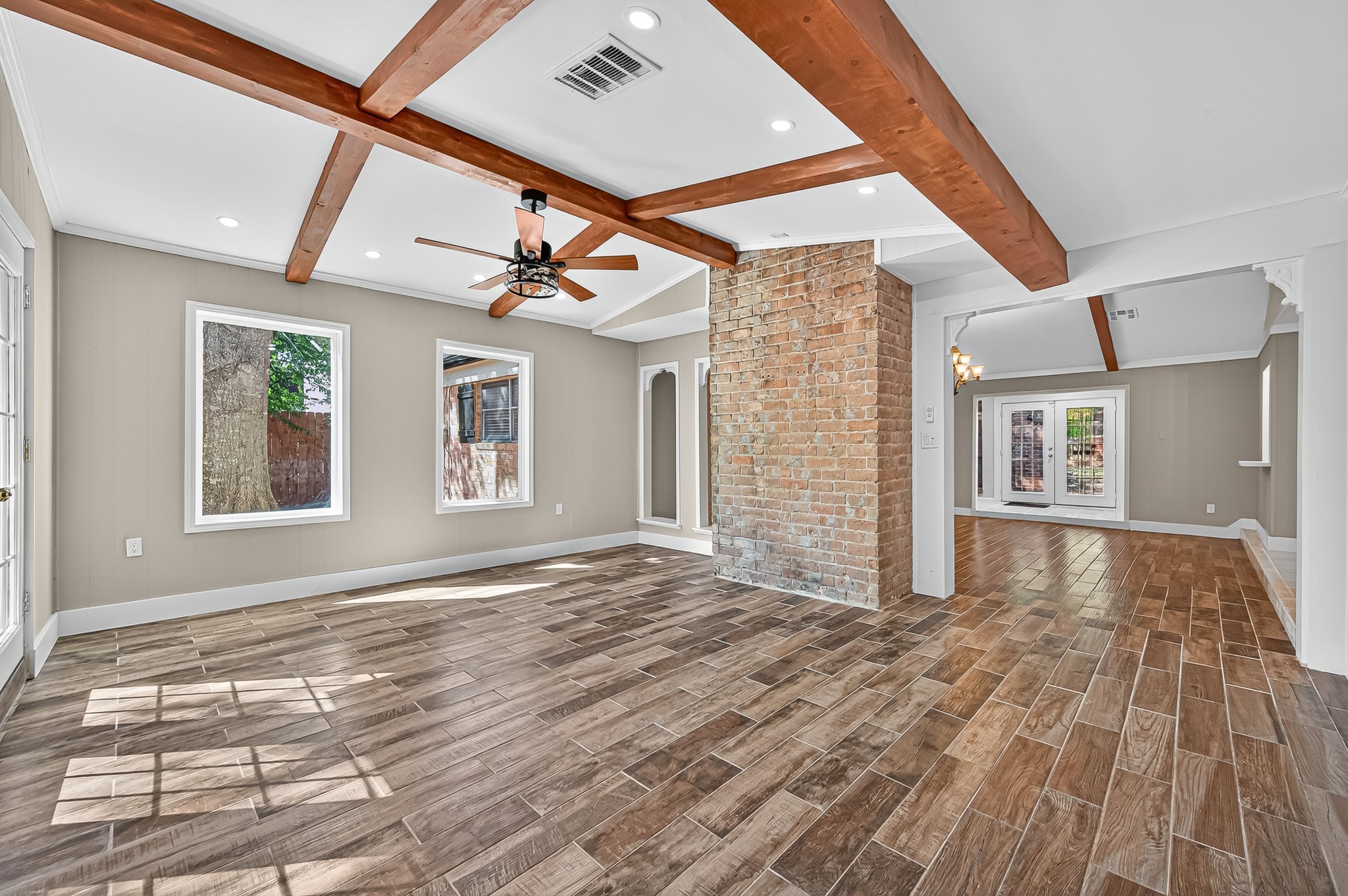 13903 Chevy Chase Drive Houston, TX 77077 - Photo 12 of 48 a view of an empty room with wooden floor and a window