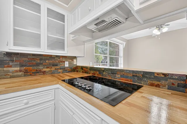 a kitchen with a stove a sink and cabinets