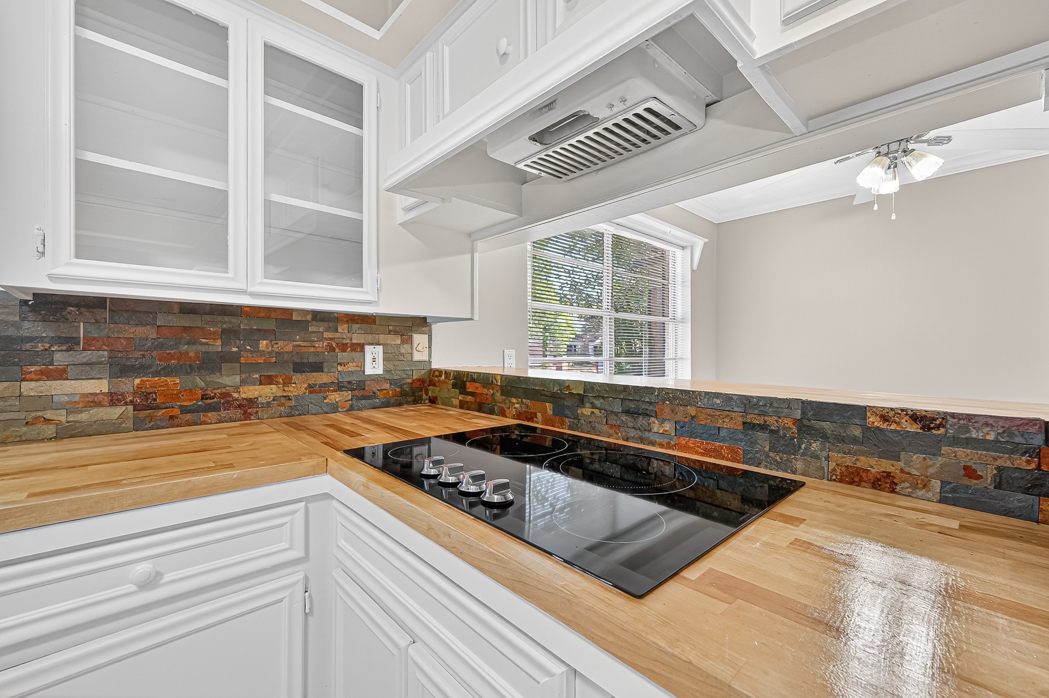 13903 Chevy Chase Drive Houston, TX 77077 - Photo 20 of 48 a kitchen with a stove a sink and cabinets
