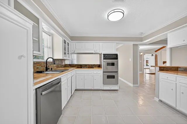 a kitchen with a sink stove and cabinets