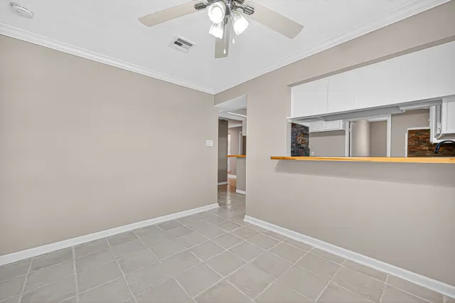 a bedroom with a bed large window and a flat screen tv