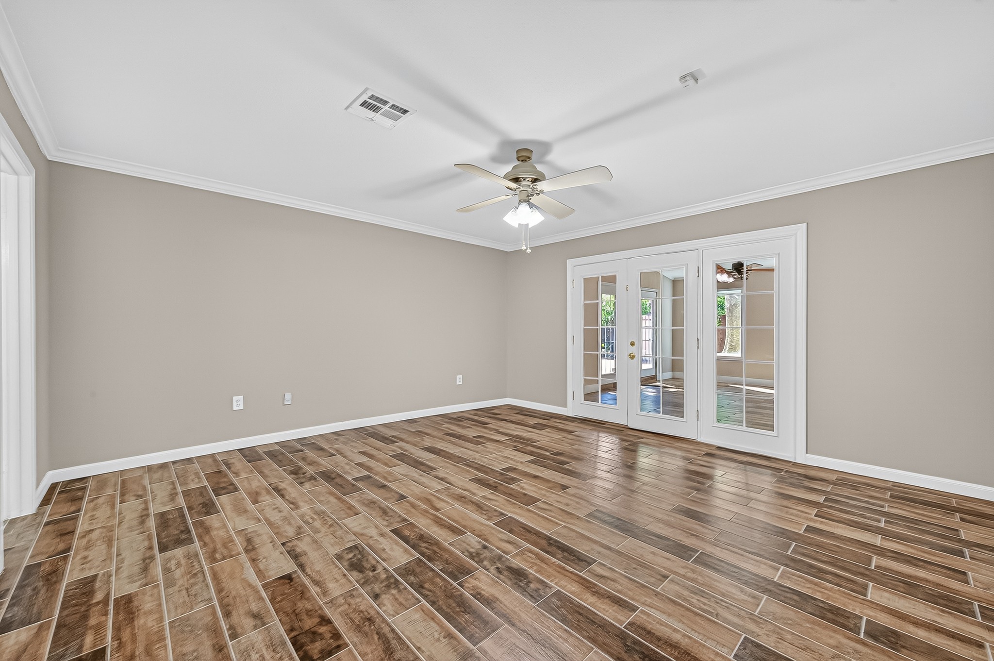 13903 Chevy Chase Drive Houston, TX 77077 - Photo 31 of 48 a view of an empty room with window and wooden floor