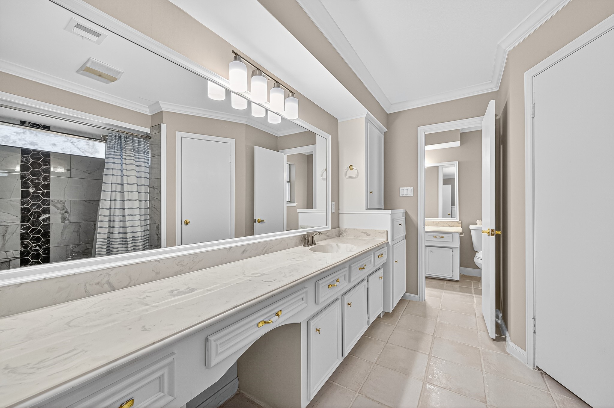 13903 Chevy Chase Drive Houston, TX 77077 - Photo 32 of 48 a spacious bathroom with a granite countertop sink and a mirror