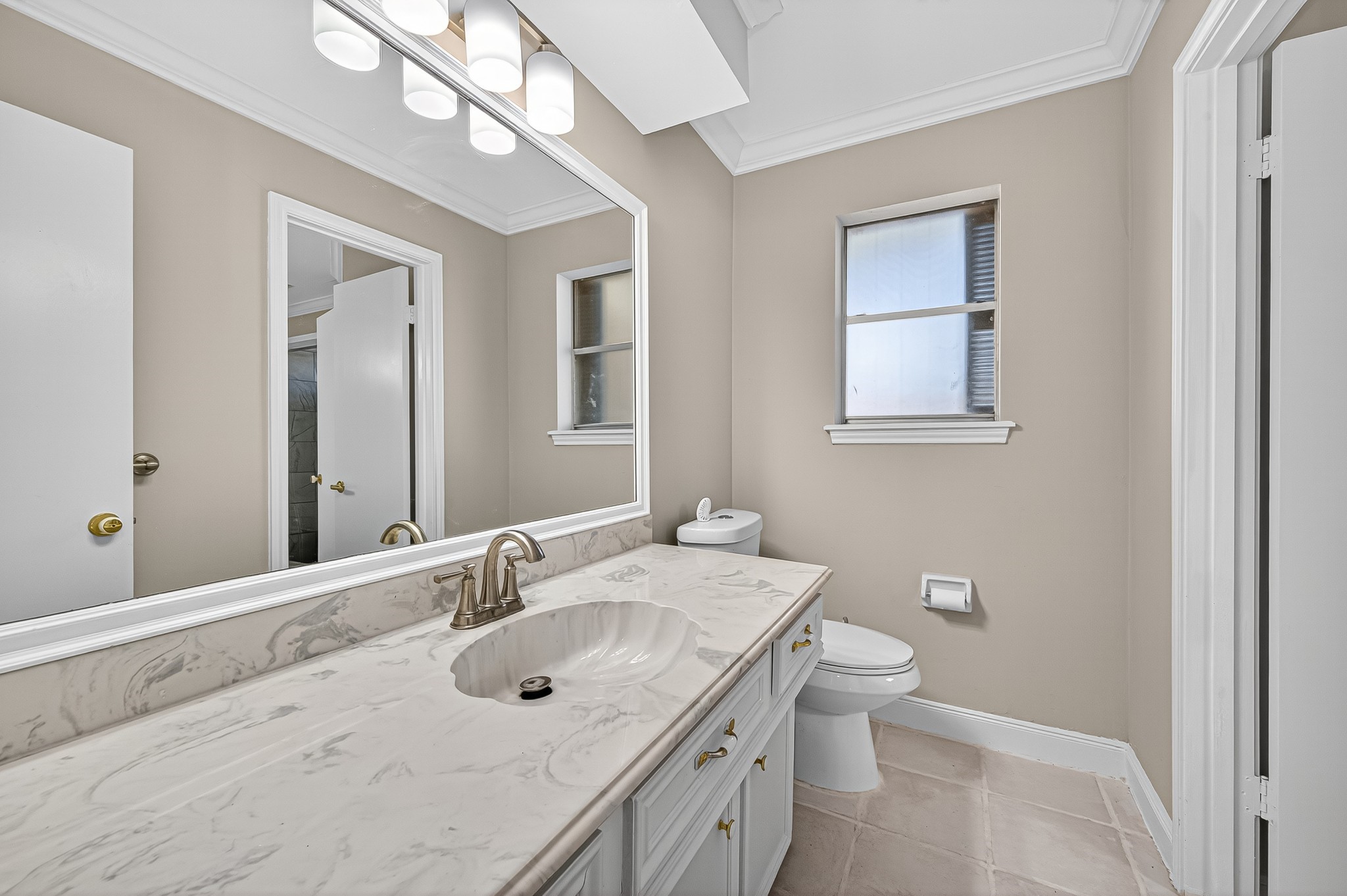 13903 Chevy Chase Drive Houston, TX 77077 - Photo 36 of 48 a bathroom with a sink a toilet and a mirror