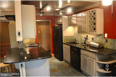 11607 Stoneview Square, Unit 2B Reston, VA 20191 - Photo 1 of 20 a kitchen with stainless steel appliances granite countertop a sink and cabinets