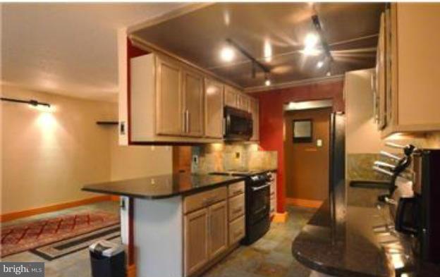 11607 Stoneview Square, Unit 2B Reston, VA 20191 - Photo 5 of 20 a kitchen with stainless steel appliances granite countertop a sink stove and cabinets