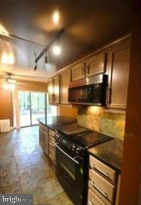 11607 Stoneview Square, Unit 2B Reston, VA 20191 - Photo 6 of 20 a kitchen with stainless steel appliances granite countertop a stove and a wooden cabinets