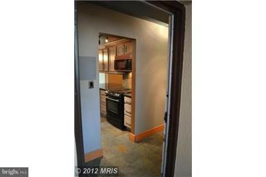 11607 Stoneview Square, Unit 2B Reston, VA 20191 - Photo 7 of 20 a view of a kitchen from a hallway