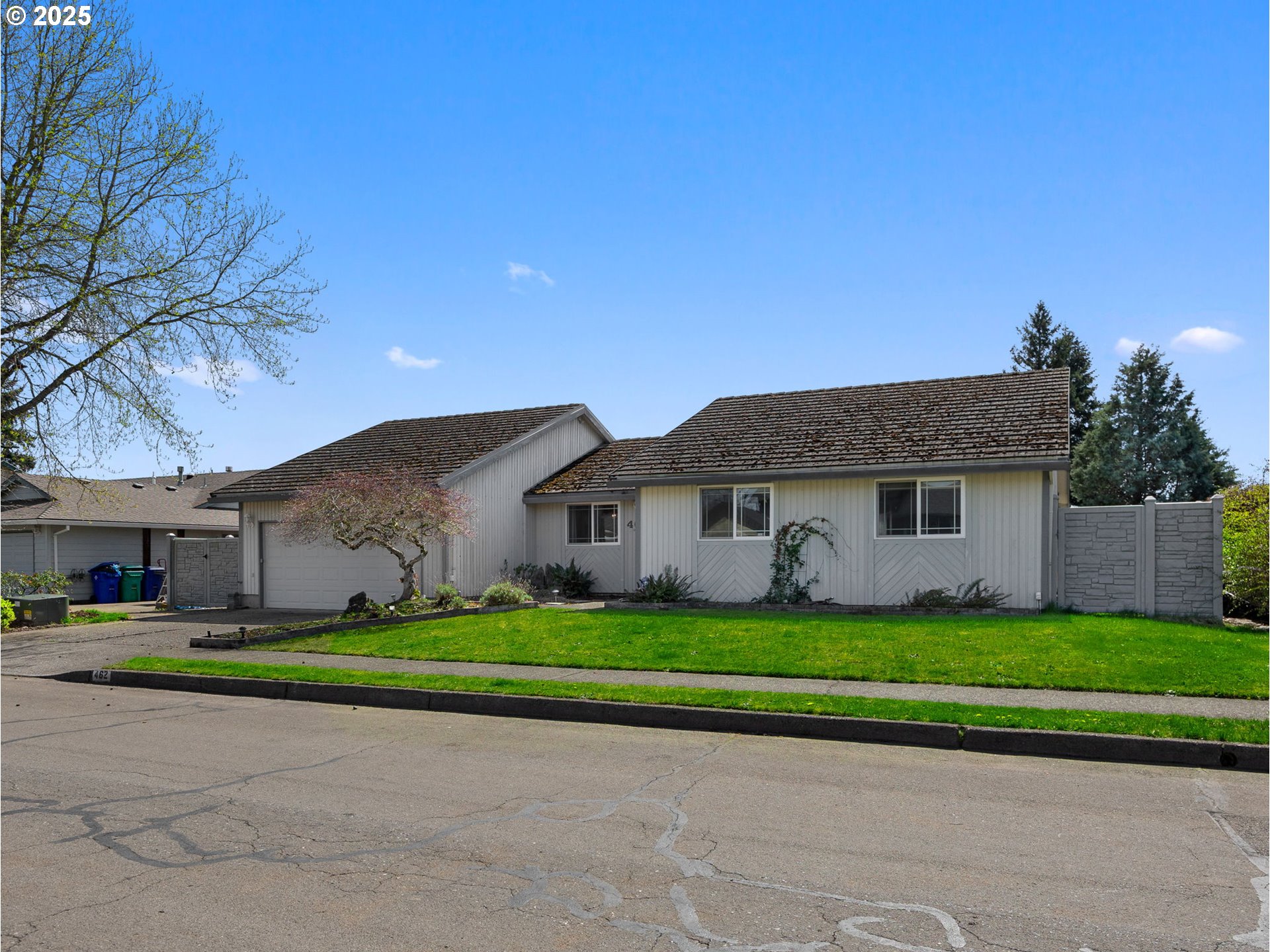 462 Northeast 24th Street Gresham, OR 97030 - Photo 2 of 37 a front view of a house with a yard and garage