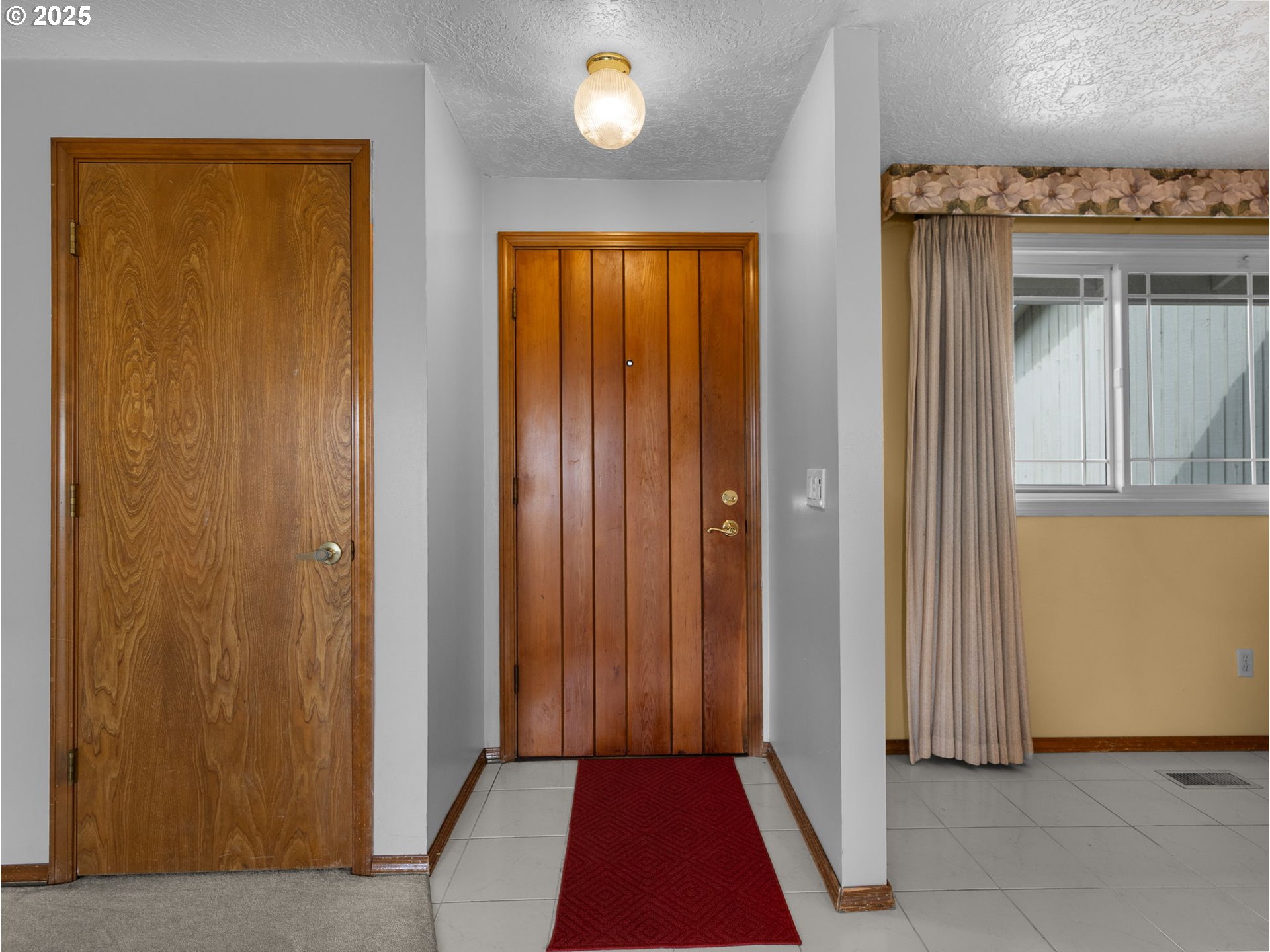 462 Northeast 24th Street Gresham, OR 97030 - Photo 5 of 37 a view of a hallway with wooden floor and a bathroom
