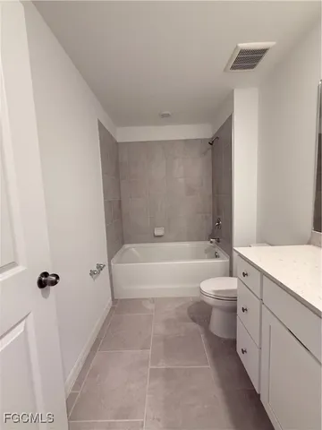 a bathroom with a toilet a sink and a mirror