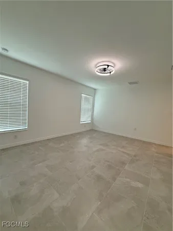 a spacious bathroom with a double vanity sink a mirror and a bathtub