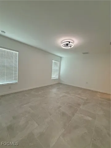 a spacious bathroom with a double vanity sink a mirror and a bathtub