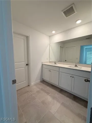 a bathroom with a shower sink and mirror