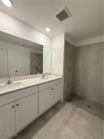 a white toilet sitting next to a white wall