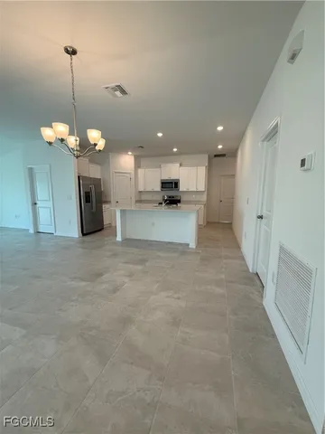 a view of a kitchen with a stove and cabinets