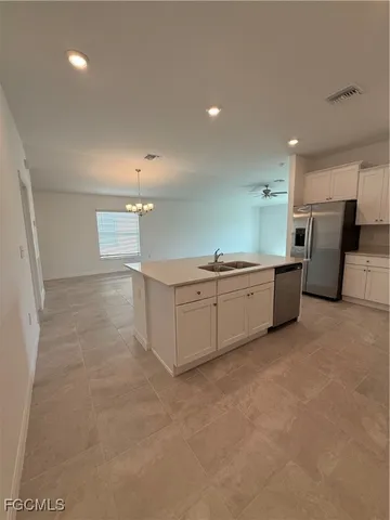 a room with a sink and cabinets