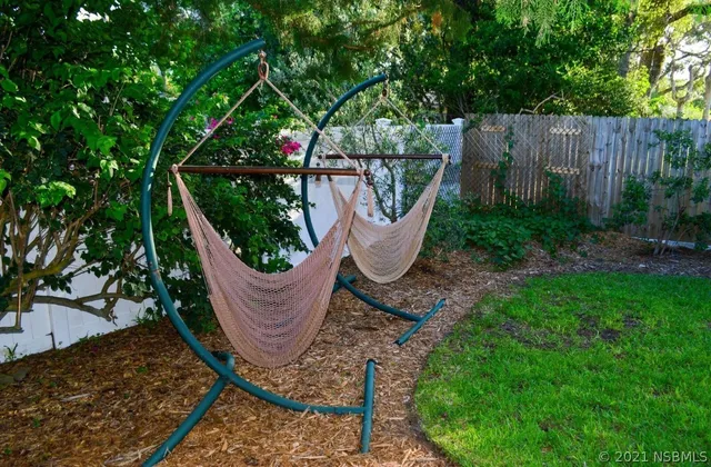 a view of a swimming pool with sitting area and garden