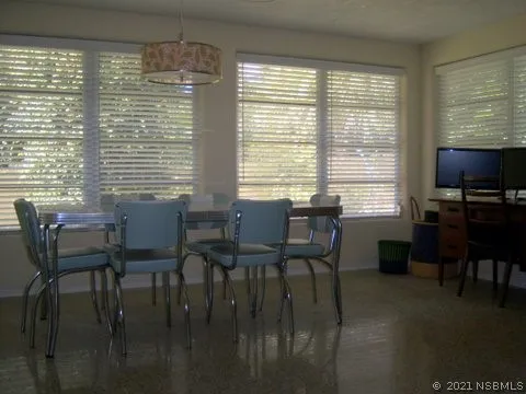 a view of a dining room with furniture and window