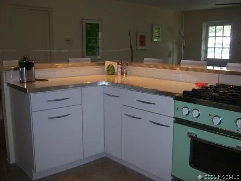 a kitchen with cabinets appliances and a sink