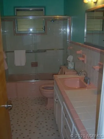 a kitchen with a sink and a refrigerator