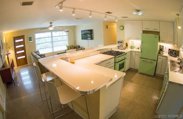 a kitchen with sink and refrigerator