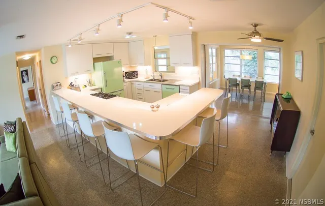 a view of a dining room with furniture wooden floor and a chandelier