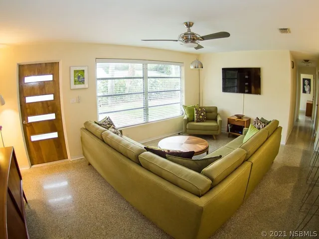 a living room with furniture and a flat screen tv