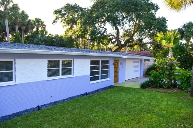 a view of an house with backyard space and garden