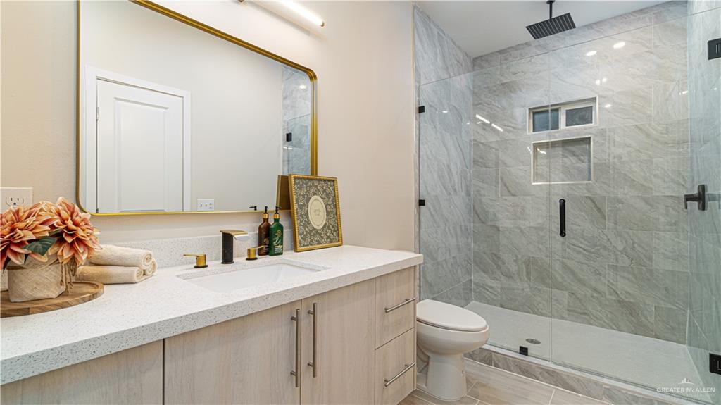 11500 North 25th Lane, Unit 2 McAllen, TX 78504 - Photo 13 of 19 a bathroom with a sink a toilet and shower