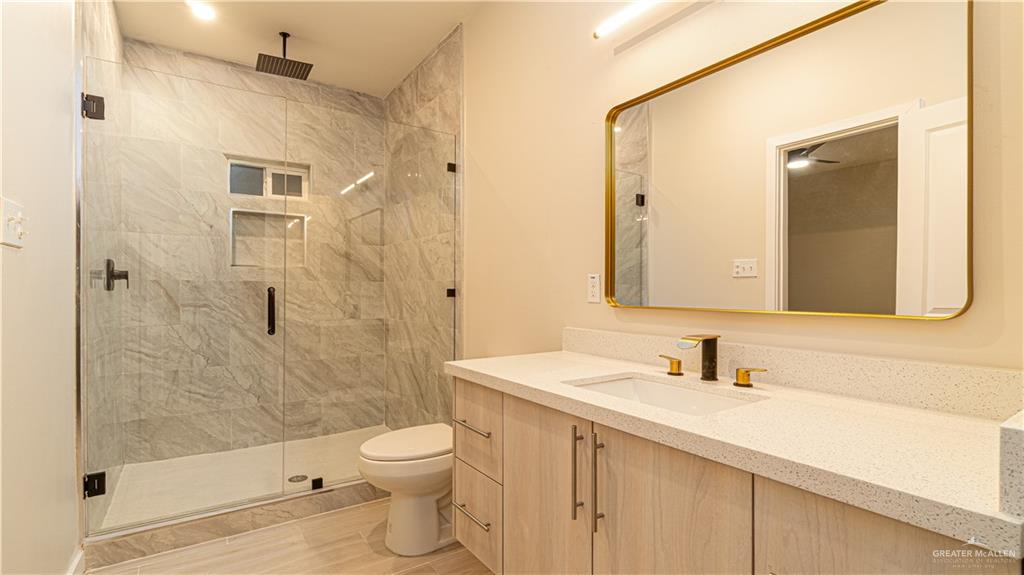 11500 North 25th Lane, Unit 2 McAllen, TX 78504 - Photo 6 of 19 a bathroom with a sink a toilet and shower