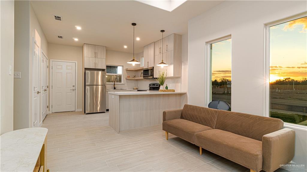 11500 North 25th Lane, Unit 2 McAllen, TX 78504 - Photo 7 of 19 a living room with furniture and a large window
