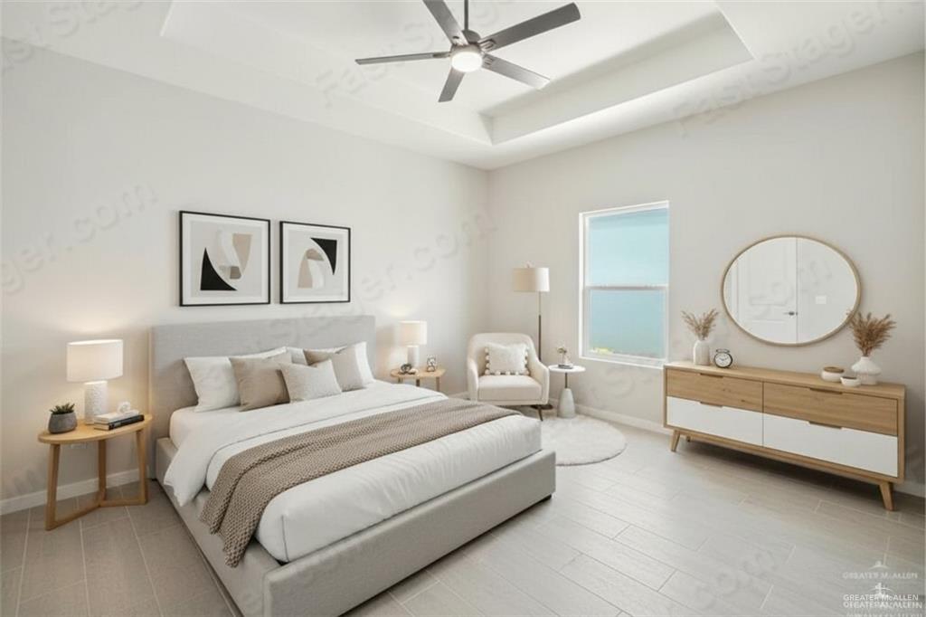 11500 North 25th Lane, Unit 2 McAllen, TX 78504 - Photo 9 of 19 a bedroom with bed and a chandelier