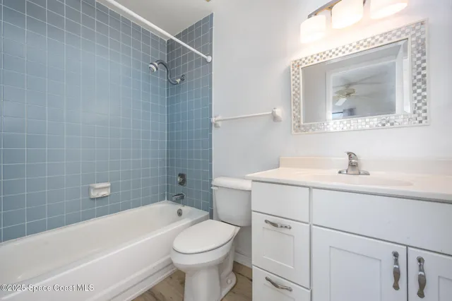 a bathroom with a toilet a sink a mirror and bathtub