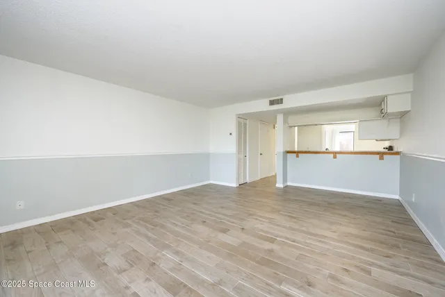 a view of a kitchen with a sink and a refrigerator
