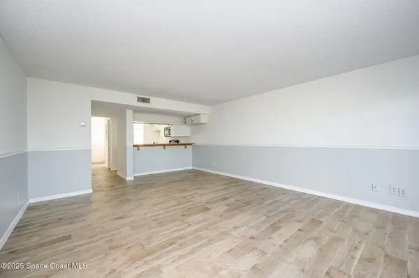 a view of a kitchen with wooden floor and a sink