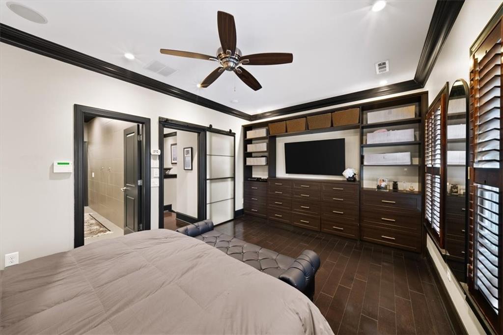 2916 Hermance Drive Northeast Atlanta, GA 30319 - Photo 19 of 38 a bedroom with a bed ceiling fan and a wooden floor