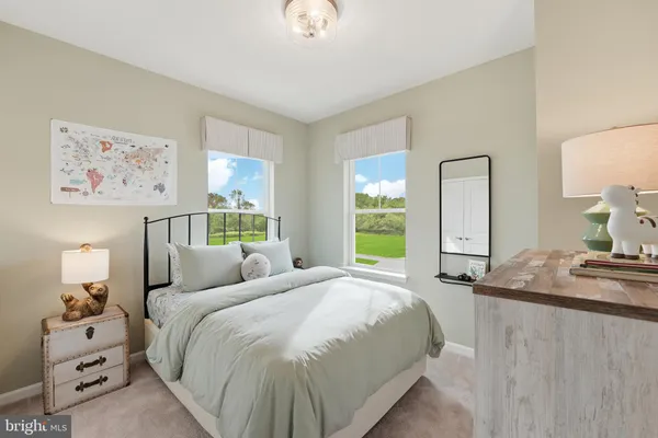 a bedroom with a bed and painting on the wall